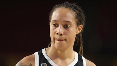 Brittney Griner Hold Up Photos Of Wife, Teammates, & Friends During Court Hearing